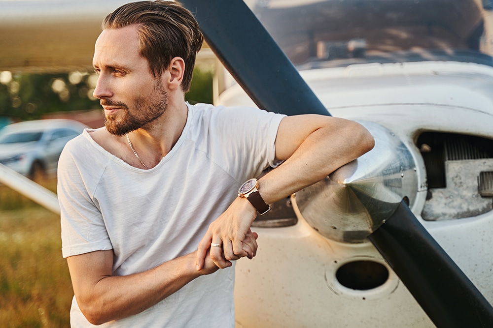 Portrait of kind man shooting near aircraft